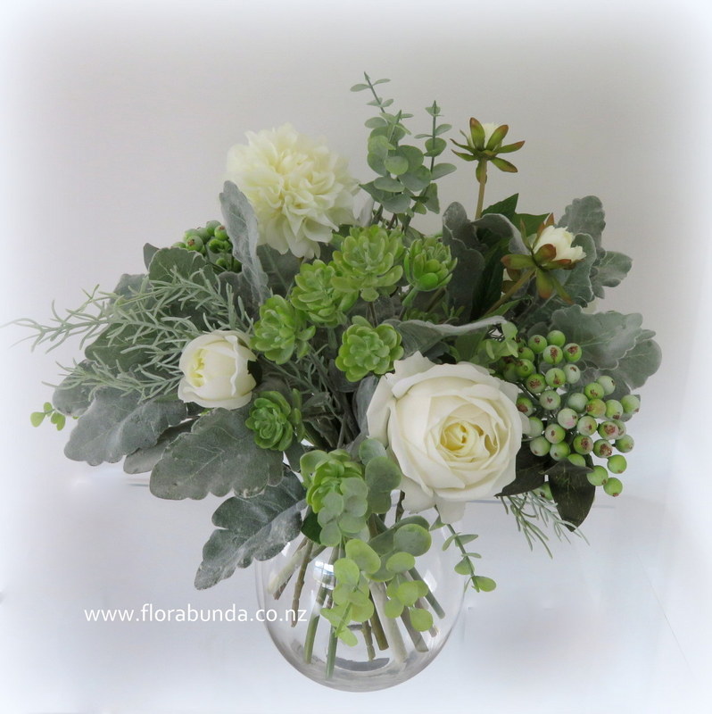 Green and white flowers in glass vase