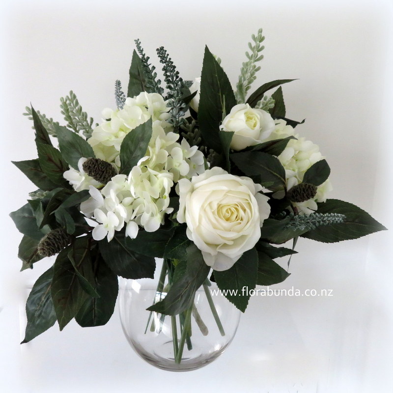Dark Green and white flowers in gass vase