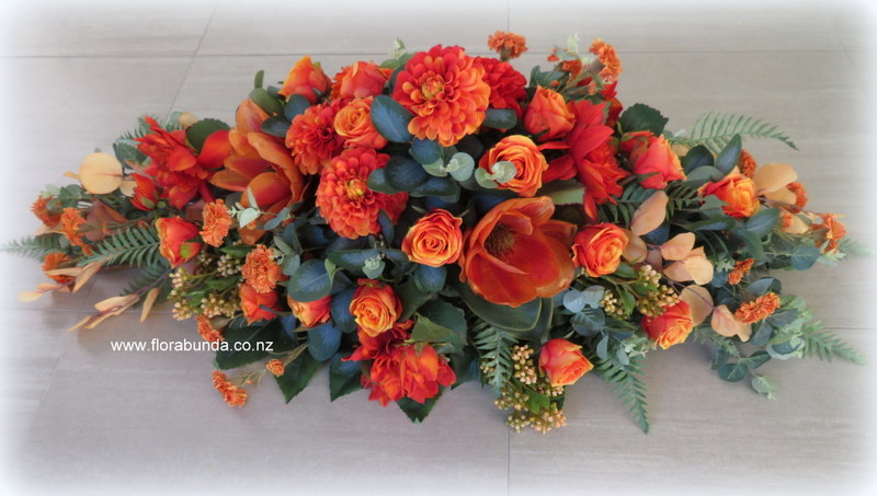 Casket spray fake flowers orange colour