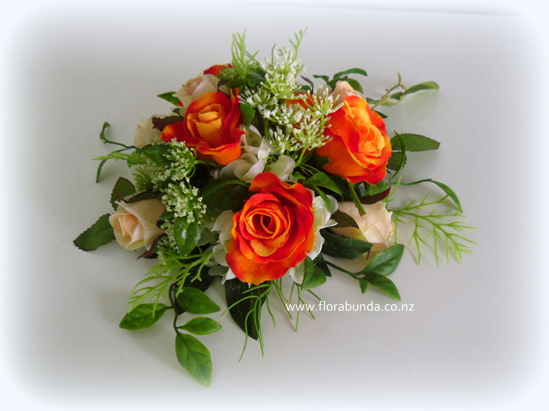 Cake florals with green leavesand orange roses