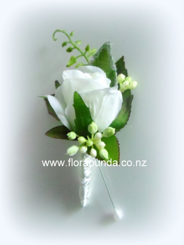 White rose artificial buttonhole bound in white