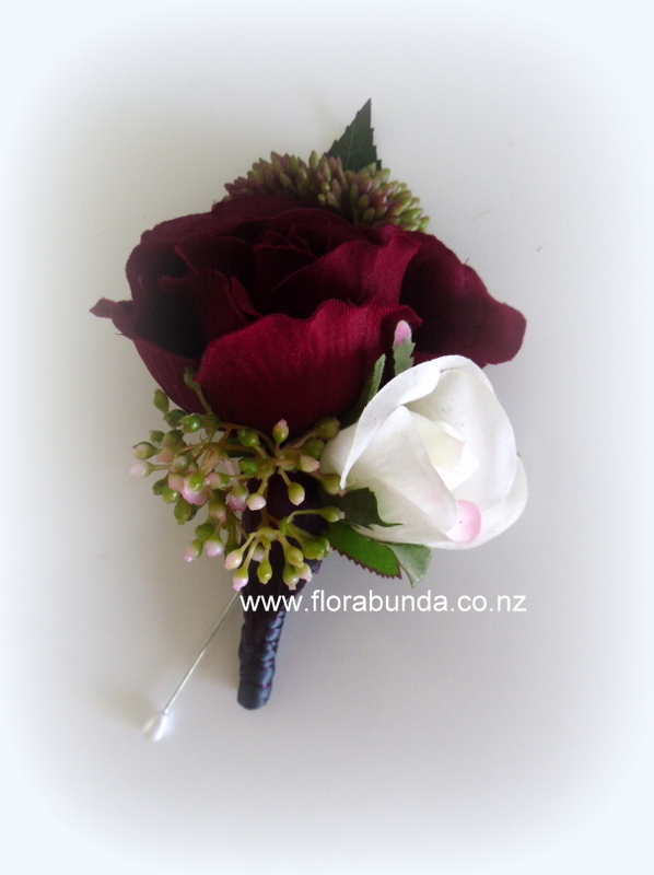 Burgundy rose man's artificial buttonhole bound in charcoal ribbon